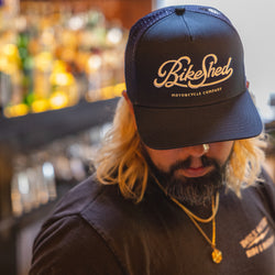 Bar staff member wearing our BSMC Garage Cap - Navy/White