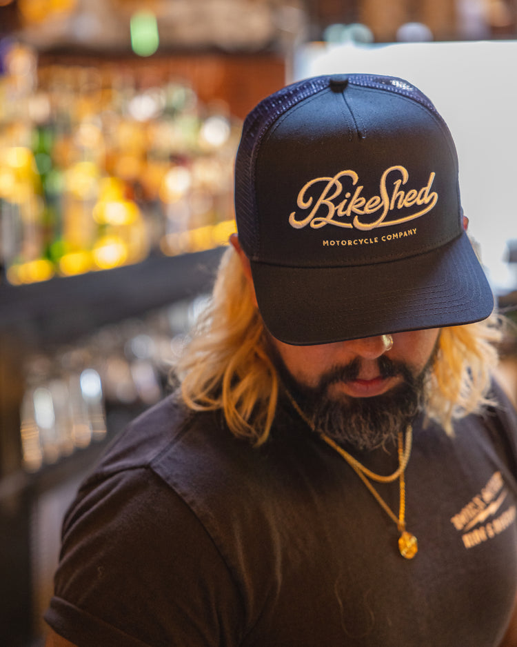 Bar staff member wearing our BSMC Garage Cap - Navy/White
