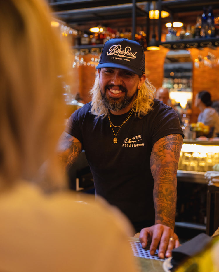Bar staff member wearing BSMC Garage Cap - Navy/White