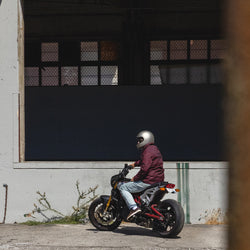 Dan sitting on his Indian Bike while wearing our BSMC Company Coach Jacket - Burgundy 