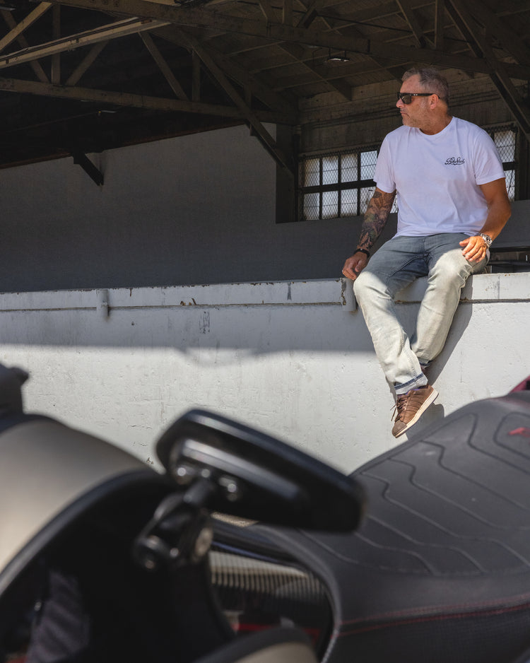 Dan sitting in the shade while wearing our BSMC Garage T Shirt - White & Black