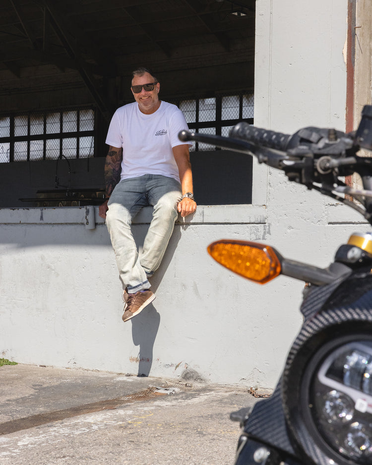 Dan smiling at the camera while wearing our BSMC Garage T Shirt - White & Black