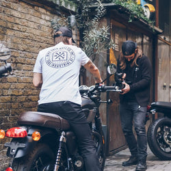 Dutch sitting on a Triumph Bonnie wearing our BSMC 1580 Roundel T Shirt - White