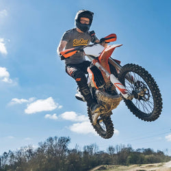 Dirt bike rider going over jump wearing our BSMC Classic T-Shirt - Grey
