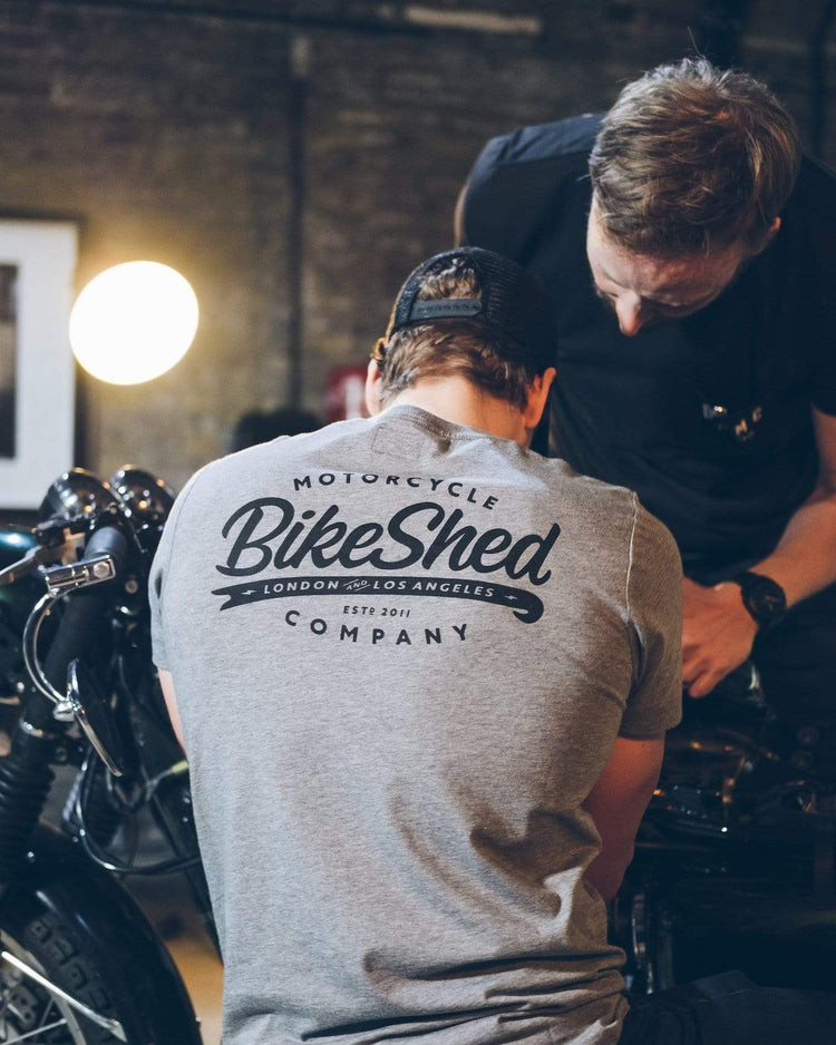 Harry wearing our BSMC Company T-Shirt - Grey while working on his bike