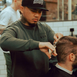 Isaac cutting hair while wearing our BSMC Estd. LS220P - Khaki
