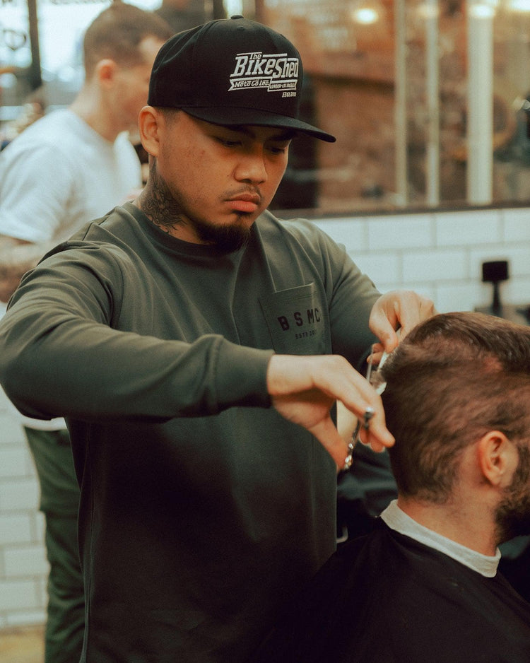 Isaac cutting hair while wearing our BSMC Estd. LS220P - Khaki