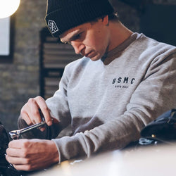 Harry working on his bike wearing our BSMC ESTD. Sweatshirt - Grey Marl