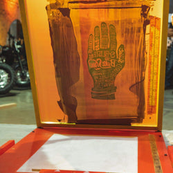 Handmade print being screen printed