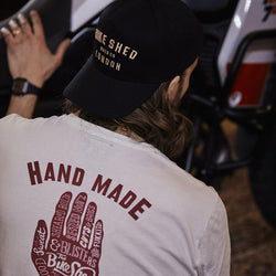 Gareth inspecting his bike while wearing our BSMC Handmade T Shirt - Cream