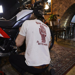 Gareth working on his bike while wearing our BSMC Handmade T Shirt - Cream, back