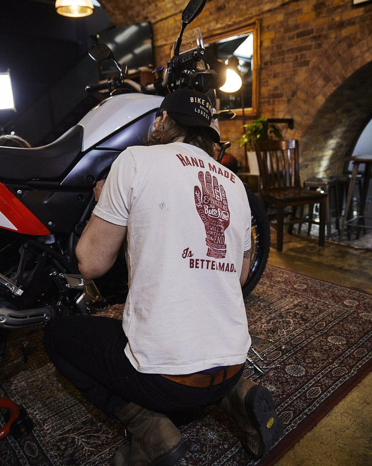 Gareth working on his bike while wearing our BSMC Handmade T Shirt - Cream, back