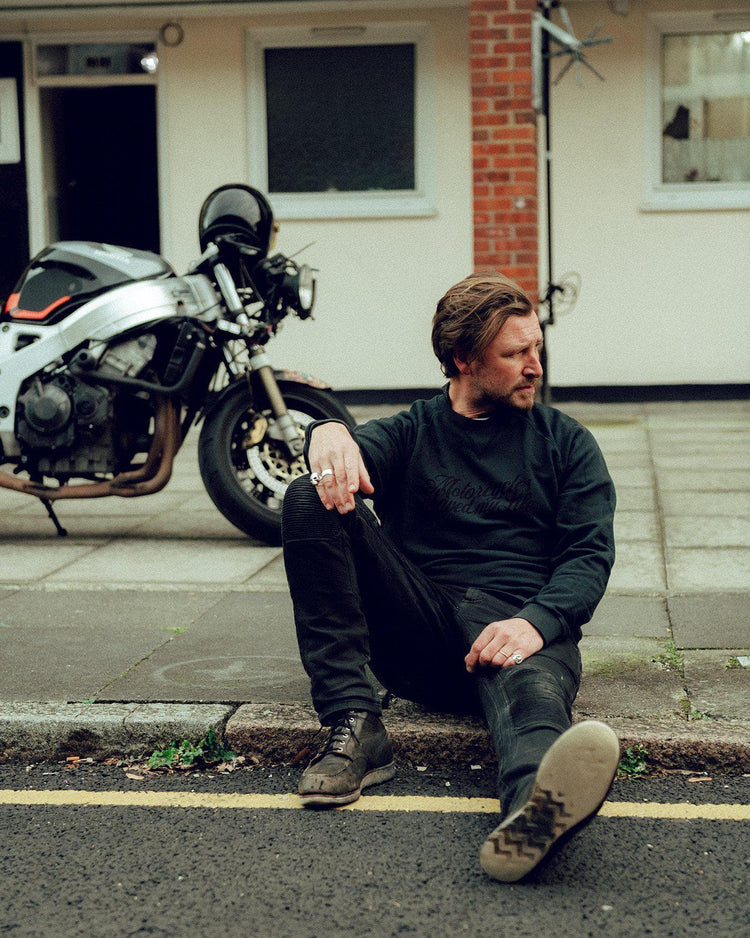 Donny posing while wearing our BSMC 'Motorcycles Saved My Life' Sweatshirt - WASHED BLACK
