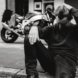 Donny posing while wearing our BSMC 'Motorcycles Saved My Life' Sweatshirt - WASHED BLACK