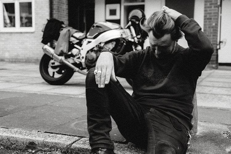 Donny posing while wearing our BSMC 'Motorcycles Saved My Life' Sweatshirt - WASHED BLACK