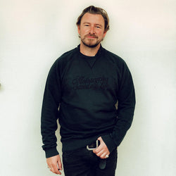 Donny posing while wearing our BSMC 'Motorcycles Saved My Life' Sweatshirt - WASHED BLACK