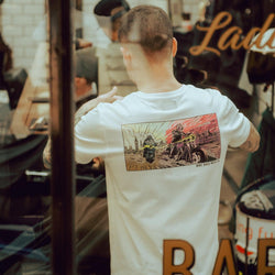 Luca wearing our BSMC Mural T Shirt - White while cutting hair
