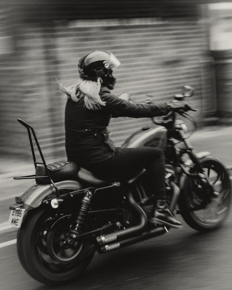Clare wearing our BSMC Resistant Women's Skinny Jean - Black while riding her Harley