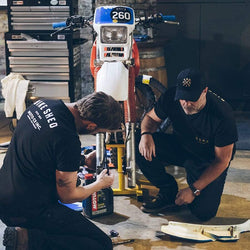 Dan working on his bike wearing our BSMC Spanners Cap - Black & Gold