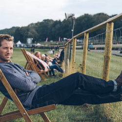 Model wearing BSMC X Umberto Luce Boot - Coffee Brown at a race track