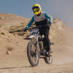 Model riding in the desert wearing our BSMC XT Race Jersey - BLUE/WHITE/BLACK