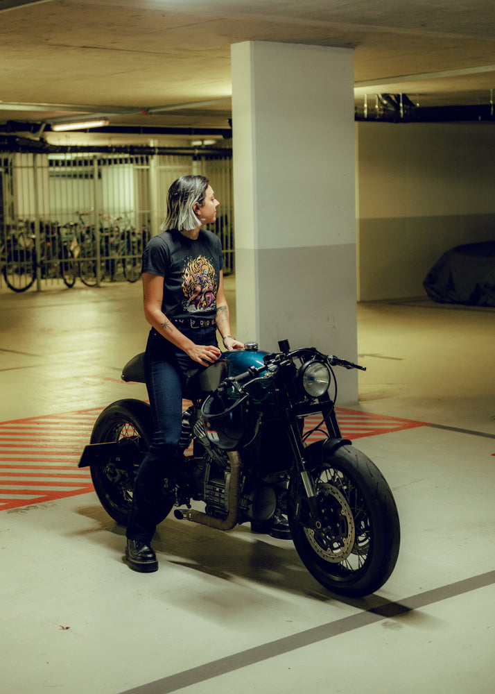 Model sitting on Honda CX500 wearing our BSMC Women's Speed Demon T-Shirt - Washed Black