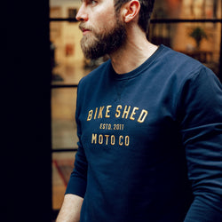Alen posing, wearing our BSMC Moto Co. Sweat - Navy/Mustard