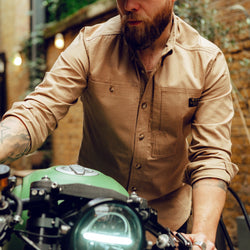 Jimbo pushing his bike wearing our BSMC Ripstop Utility Shirt MKII - TAN