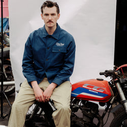 Joe sitting on a Honda CG in our BSMC Chain Stitch Chore Jacket - Blue