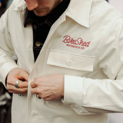 Steve buttoning up our BSMC Chain Chore Jacket - Ecru