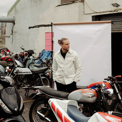 Steve posing amongst bikes in our BSMC Chain Chore Jacket - Ecru