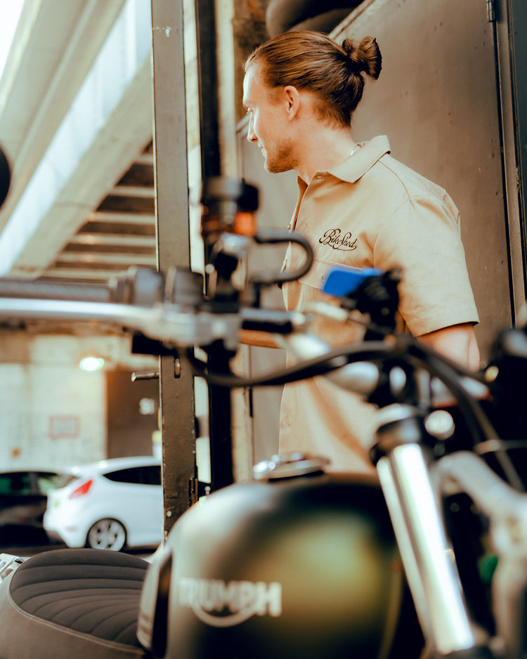 Steve wearing our BSMC Garage Shirt - Tan & Black with his Triumph in shot