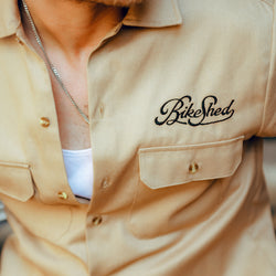 Steve wearing our BSMC Garage Shirt - Tan & Black, logo close up