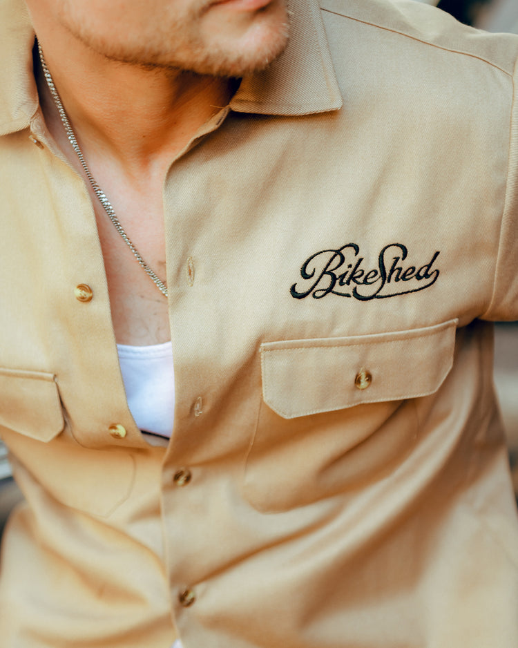 Steve wearing our BSMC Garage Shirt - Tan & Black, logo close up