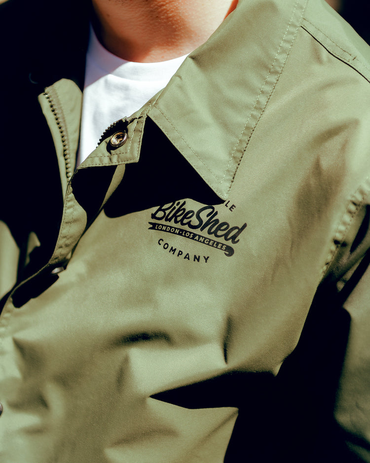 Close up shot of Joe wearing our BSMC Company Coach Jacket - Khaki Green