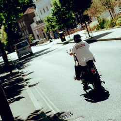 James riding his Harley in the sun wearing our BSMC Company T-Shirt - Off White
