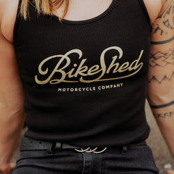 Model posing wearing our BSMC Women's Garage Vest - Black