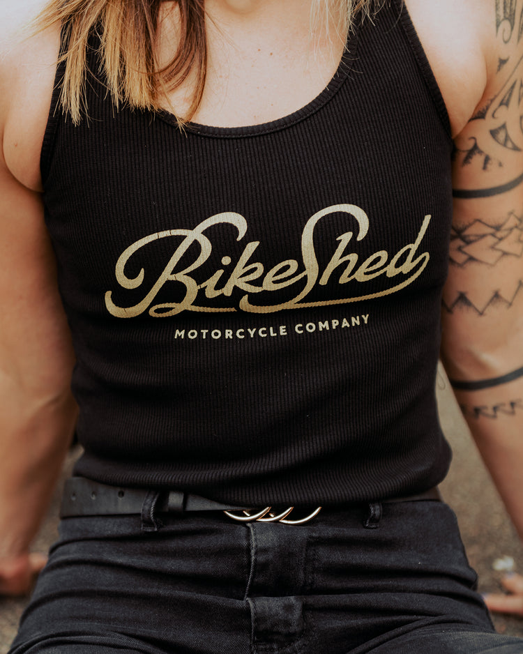 Model posing wearing our BSMC Women's Garage Vest - Black