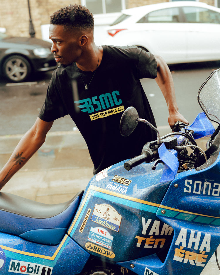 Model wheeling his bike wearing our BSMC XT T Shirt - Black