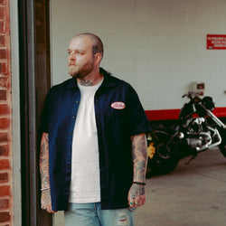 Liam posing in our BSMC Garage Patch Shirt - Navy