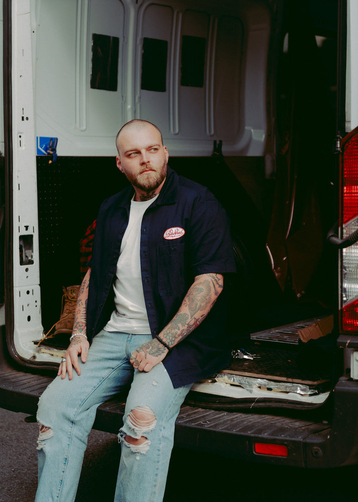 Liam wearing our BSMC Garage Patch Shirt - Navy