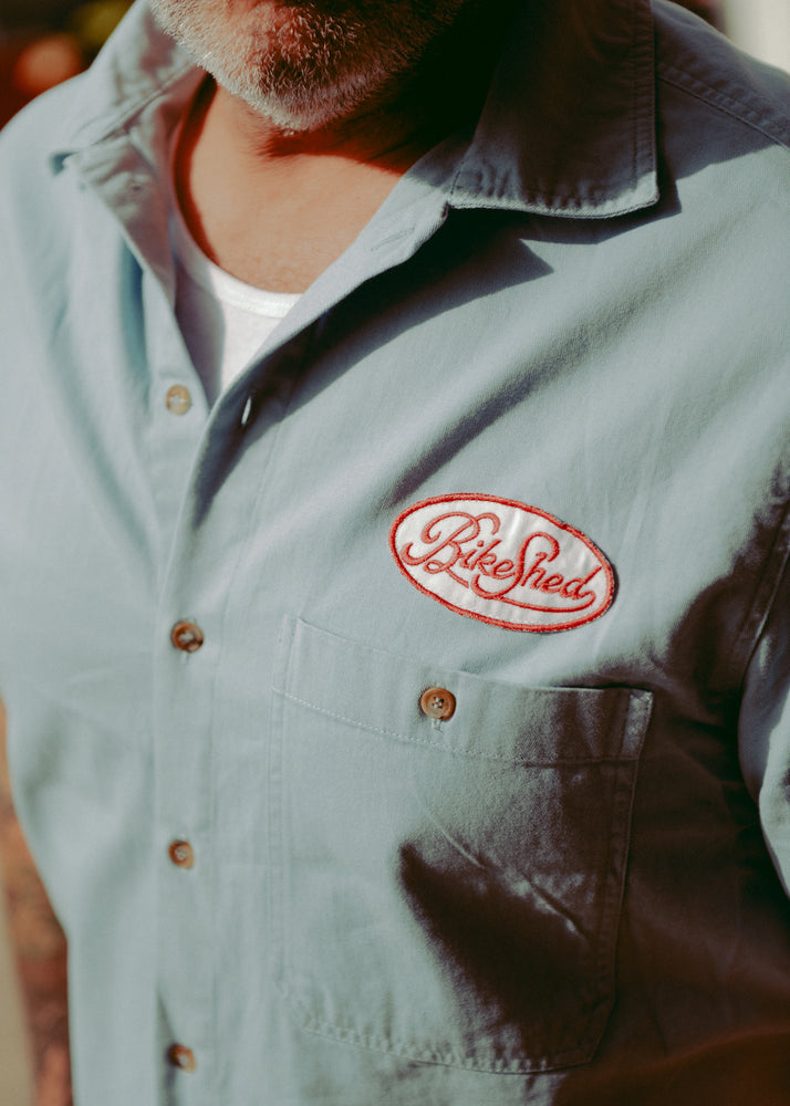 Dan wearing our BSMC Garage Patch Shirt - Blue, close up