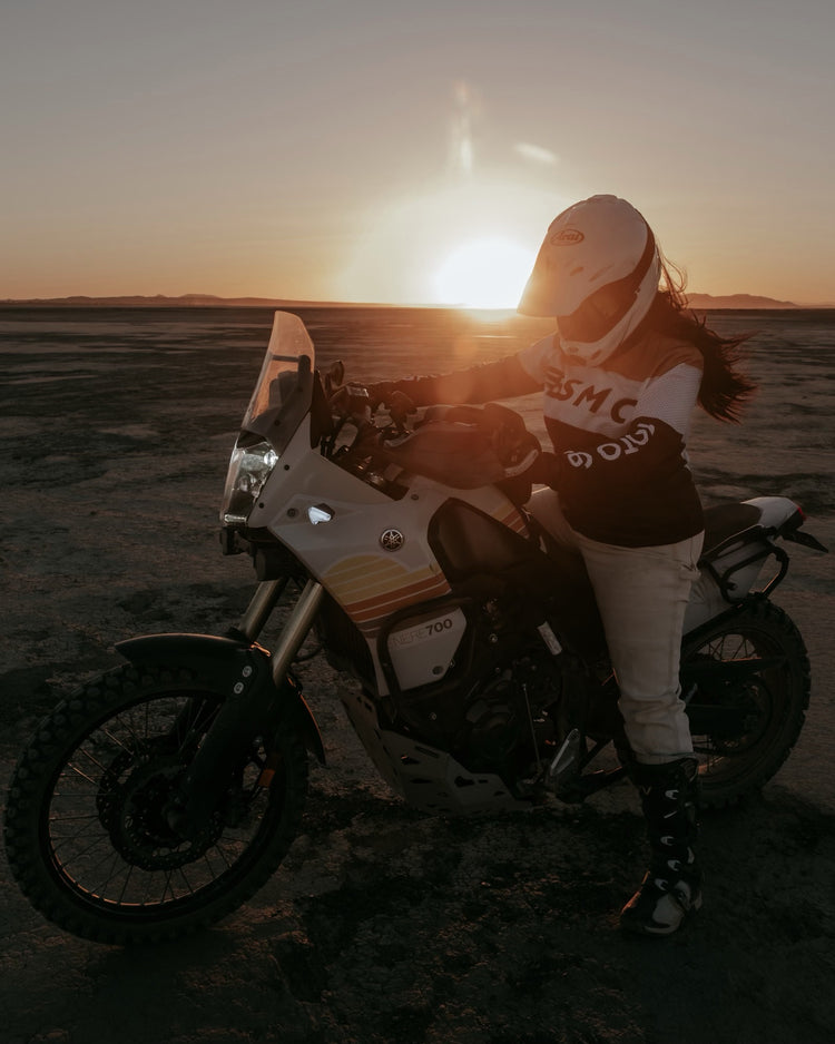 Caro sitting on her Tenere wearing our BSMC Wing Race Jersey - Gold
