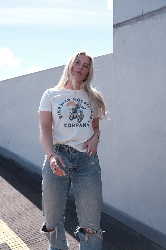 Brogan wearing our BSMC Women's Sunset T-Shirt - Off White