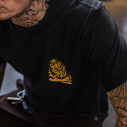 Model wearing our BSMC Speed Demon T-Shirt - Washed Black, logo close up