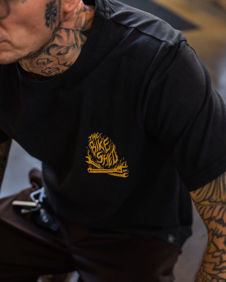 Model wearing our BSMC Speed Demon T-Shirt - Washed Black, logo close up
