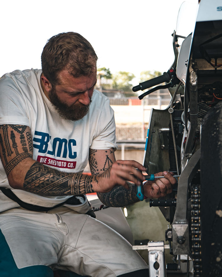 Mark wearing our BSMC XR T Shirt - Off White working on his bike